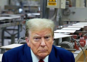 Composite image with Trump headshot over pic of a ceramic tile factory. TUC speaks out on at-risk manufacturers.