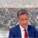 Ed Miliband in front of an image of parliament