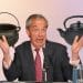 Nigel Farage in front of a black pot and a black kettle