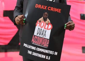 Dr Krystal Martin Holds Placard in Front of Drax AGM
