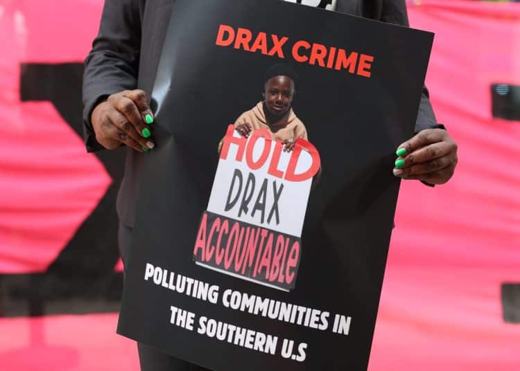 Dr Krystal Martin Holds Placard in Front of Drax AGM