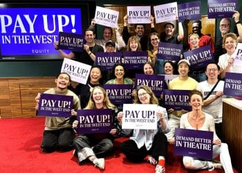 Equity members hold placards supporting the union's Pay Up! campaign in London's West End