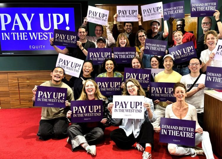 Equity members hold placards supporting the union's Pay Up! campaign in London's West End