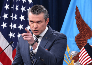 Pete Hegseth points at someone or something with his index finger