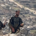 Israeli occupation soldiers photographed against a backdrop of rocky hills in April 2026