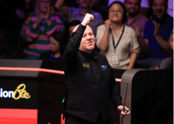 John Higgins celebrates victory over Ronnie O'Sullivan
