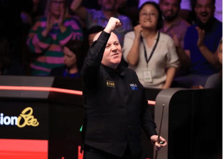 John Higgins celebrates victory over Ronnie O'Sullivan