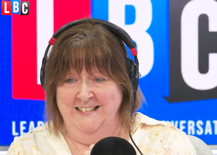 LBC host Shelagh Fogarty infront of her radio mic, talking to guest, Steve, on her show
