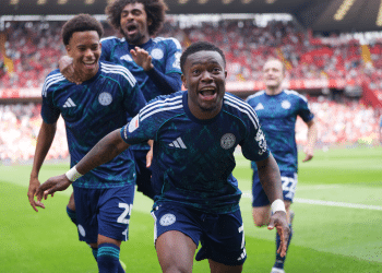 Abdul Fatawu celebrates with his Leicester teammates after scoring the winner against Charlton in August 2025. His mouth is open as he runs towards the photographer and his two teammates smile and laugh behind him