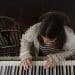 A girl plays a piano in a publicity still from 'Little Rock', from the Dementia Doesn’t Care campaign