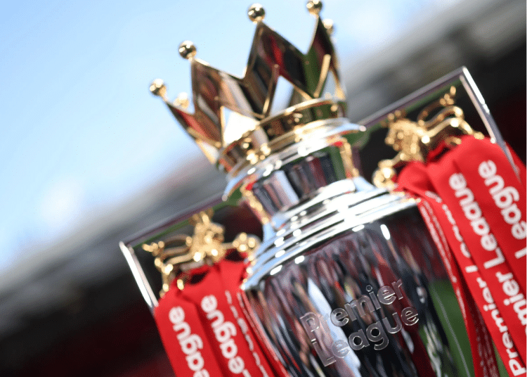 A close-up of the regal looking Premier League trophy that has 'Premier League' engraved into the silver at the front and tassels hanging from the sides