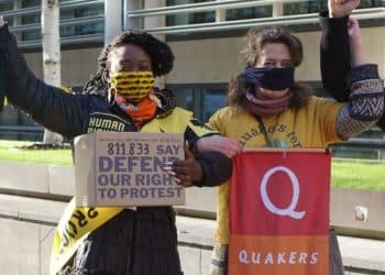 Protesters hold banner saying Quakers For Peace and placard saying 811,833 Say Defend Our Right To Protest. Faith leaders criticise protest bill.