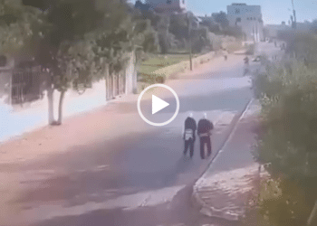 A moment of calm before the car hits the schoolgirls as they walk alongside the empty street during the daytime in Palestine