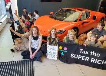 Take Back Power supporters stage a sit-in in a Ferrari dealership