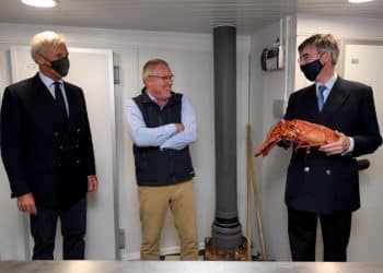 Richard Drax MP, the restaurant owner and Jacob Rees-Mogg holding a lobster