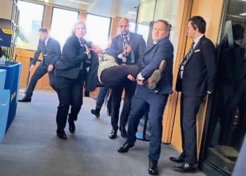 Security carry a protester away from the Aviva AGM