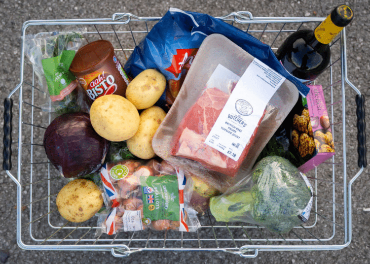 In this photo illustration, a basket of shopping filled with produce used in a traditional Sunday roast dinner for families is displayed on October 23, 2022 in Cardiff, Wales. The cost of a home-cooked Sunday roast for a family of four has reached its highest level in over a decade with inflation at 10.1%.