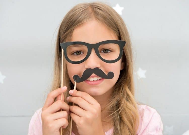 Child with a fake moustache and glasses to get around age verification