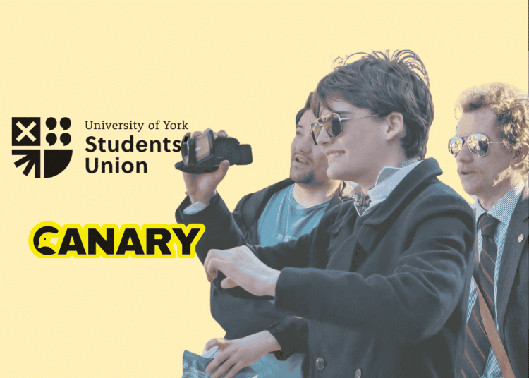A picture of a Restore Britain Society fan holding a camera. On the left are both the University of York Student Union Logo and the Canary UK logo