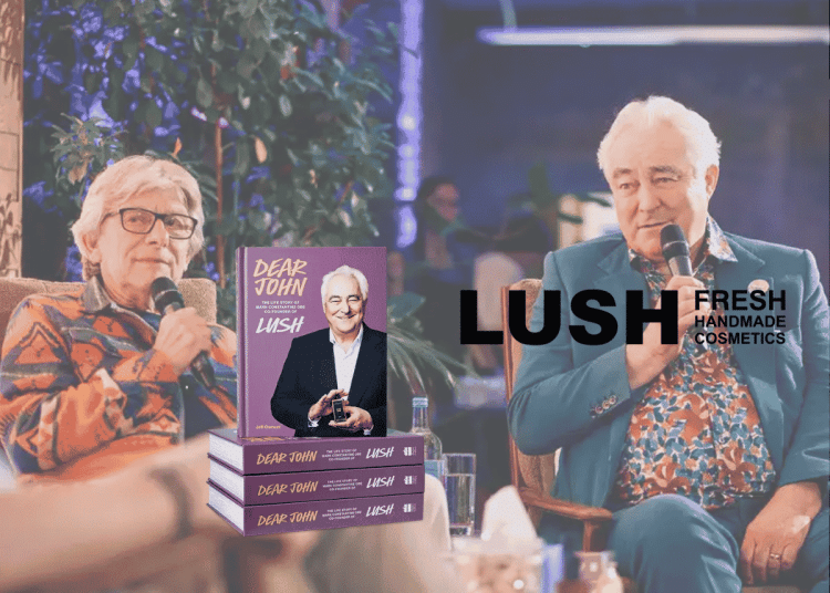 Mark Constantine and Jeff Osment talking at the book launch. In the foreground is a stack of the book 'dear John' and the LUSH logo