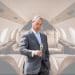Nigel Farage in front of an image of a private jet