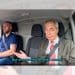 Nigel Farage and Robert Kenyon, both of Reform, sat in the front seats of a van