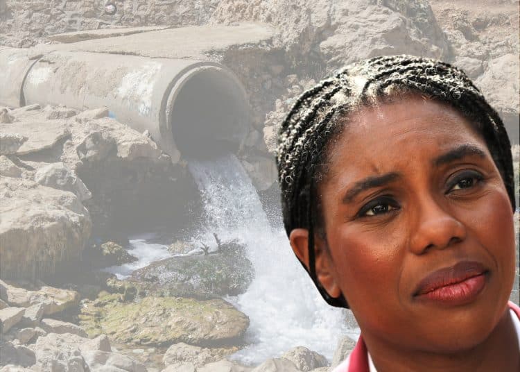 Kemi Badenoch of the Tories in front of a sewage pipe