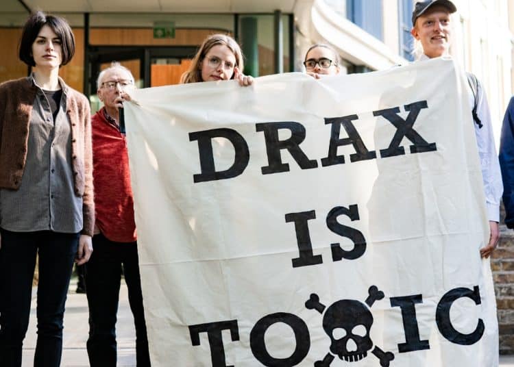 Axe Drax activists hold a banner saying Drax Is Toxic