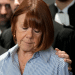Gisele Pelicot, with her head and gaze down towards the floor and her son's hand on her shoulder, gives a statement inside the courthouse after a verdict in the Pelicot case on December 19, 2024 in Avignon, France. Gisele Pelicot's ex-husband, Dominique Pelicot, and 50 other men were convicted on charges of raping her over a multiyear period, in encounters arranged by Mr. Pelicot while she was drugged and unconscious.