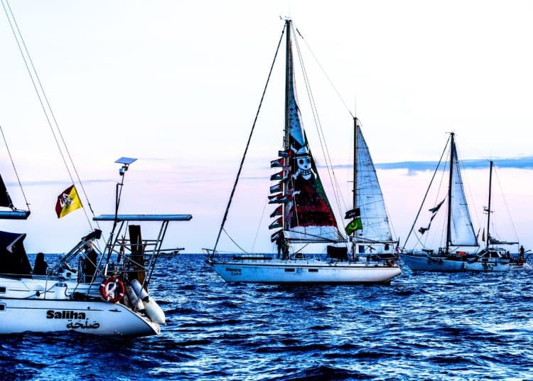 Global Sumud Flotilla boats sailing at twilight