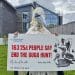 Rob Pownall, in gannet costume, holds a giant cheque representing a petition to NatureScot