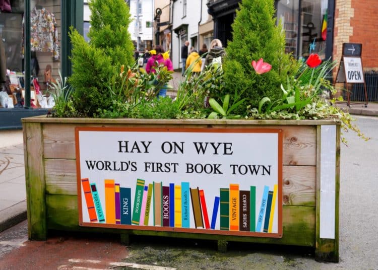 Sign on a planter says Hay On Wye World's First Book Town Hay Festival Airbnb