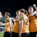 Hull City AFC players hug one another in celebration on the pitch