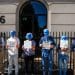 Protesters wearing blue masks outside Rio Tinto office.