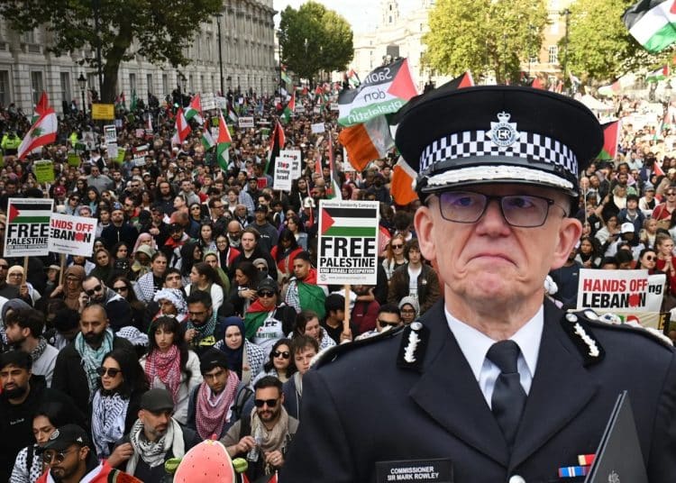 Composite image of Met police commissioner Mark Rowley in front of a wide shot of pro-Palestine marchers