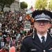 Composite image of Met police commissioner Mark Rowley in front of a wide shot of pro-Palestine marchers