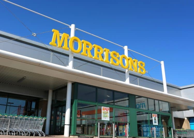 Morrisons supermarket sign against a blue sky Male sanitary bins