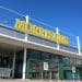 Morrisons supermarket sign against a blue sky Male sanitary bins