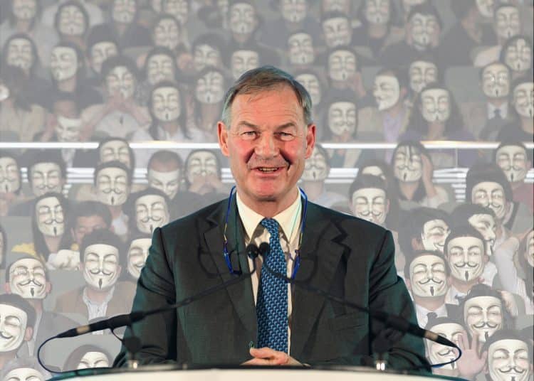 Rupert Lowe in front of masked face Restore