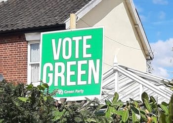 Placard in front of house saying Vote Green
