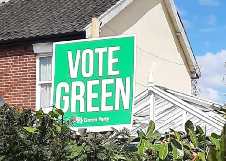 Placard in front of house saying Vote Green