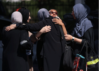 Female Muslim mosque members embrace in the parking lot of the Islamic Center of San Diego (ICSD) on May 19, 2026 in San Diego, California.