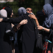 Female Muslim mosque members embrace in the parking lot of the Islamic Center of San Diego (ICSD) on May 19, 2026 in San Diego, California.