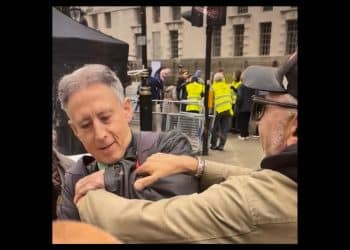 a man grabs Peter Tatchell at the Rally Against Antisemitism