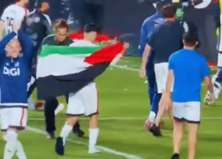 Akhomach celebrates with the Palestinian flag after his team Rayo Vallecano’s win over Strasbourg