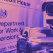 DWP sign at Caxton House in the background. A Volvo car and CCTV camera in the foreground top and bottom right of the image.