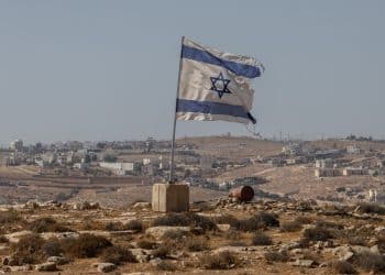 A tattered Israel flag flies near a West Bank settlement