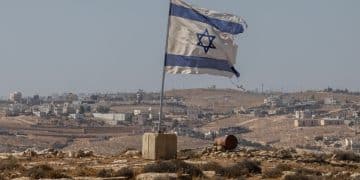 A tattered Israel flag flies near a West Bank settlement