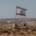 A tattered Israel flag flies near a West Bank settlement