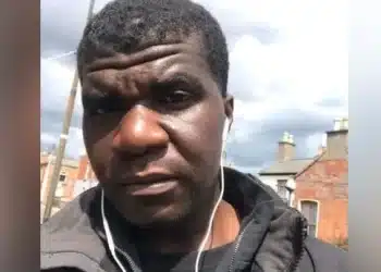 Selfie image of Yves Sakila with ear phone wires hanging from his ears